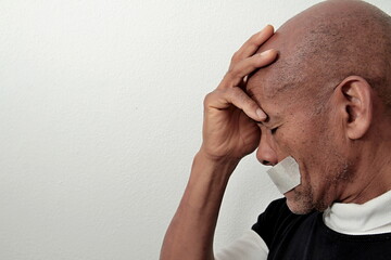 black Caribbean men feeling the pain after being discriminated on white background stock photo