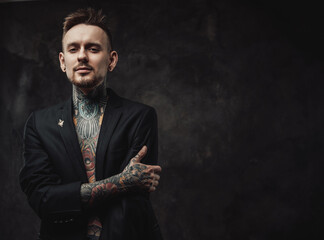 Dressed in black luxurious jacket serious and tattooed hipster person with modern haircut and short...