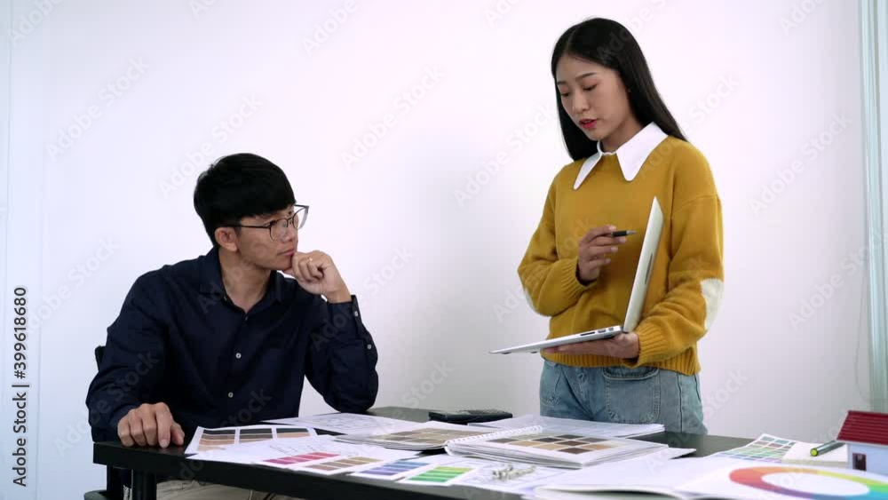 Poster team designer working graphic with color chart on new project with work tools and equipment at workp