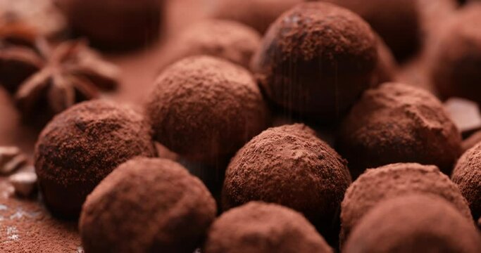 Chocolate truffles sprinkled with cocoa powder, close up view. Delicious homemade dessert.,