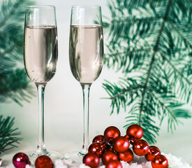 two glasses with champagne, and boxes with gifts on Christmas b