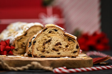 Slice of German Stollen cake, a fruit bread with nuts, spices, and dried fruits with powdered sugar traditionally served during Christmas time 