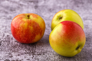 Green and red apples on blackboard or chalkboard background. Close-up on a gray background.Ideal food for diet.