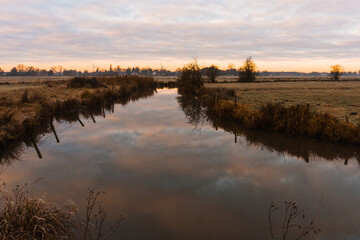 sunrise over the river in a cold winter morning, wide landscape