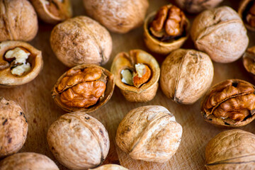 A lot of walnuts on wooden background