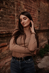 charming brunette with  stands against a beautiful wall. girl in a beret. classic clothes, amazing style