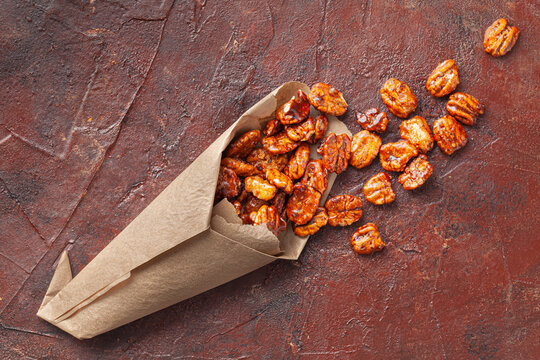 homemade candied pecans with cinnamon and sugar on rustic surface