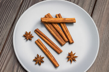 Cinnamon sticks and star anise in gray ceramic plate