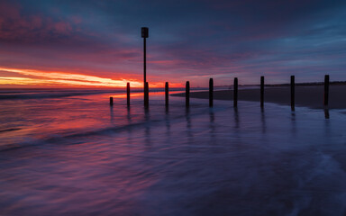 Colourful sunrise over Blyth Beach on the coast of Northunberland, England, UK. On a cold winter morning.