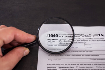 Tax Form 1040 with magnifying glass