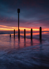 Colourful sunrise over Blyth Beach on the coast of Northunberland, England, UK. On a cold winter morning.