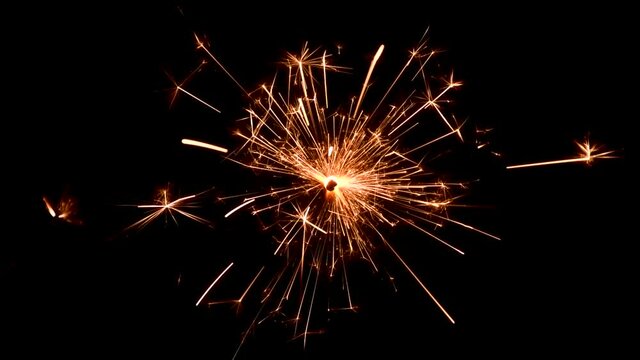 Close-up of Bengal fire burning on black background. New year sparkler