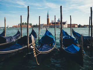 Fototapeta na wymiar Gondolas with San Giorgio Maggiore visible in the background
