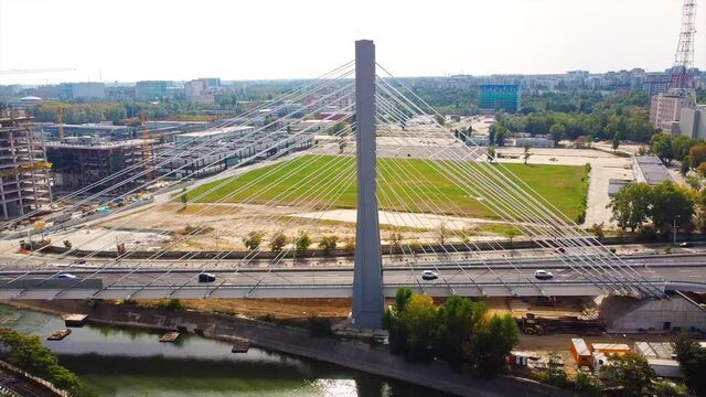 Ciurel passage, bridge over a river with moving cars, recreational complex, lake. View from the drone. Bucharest, Romania