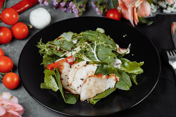 smoked chicken salad on a black plate