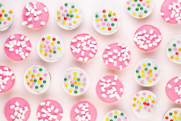 Colorful cupcakes on a white background.