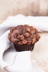 Homemade muffins with chocolate, vintage background.