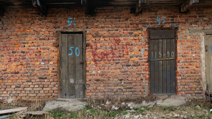 An Old Wooden Doors In An Abandoned Brick Warehouse. Background for design. Space for text.