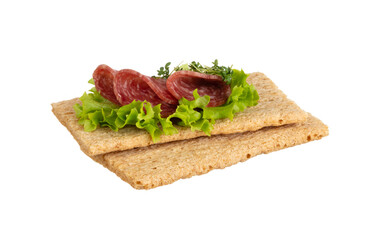 Variety of mini sandwiches with cream cheese, vegetables and salami.