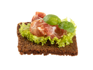 Variety of mini sandwiches with cream cheese, vegetables and salami.