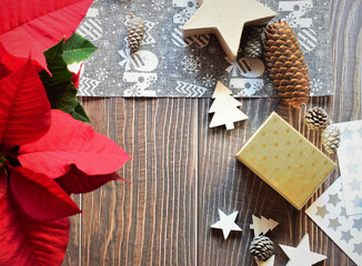 Decorative background, natural Christmas plant, stars, gift boxes, fabrics and more. All this on rustic tables. Space for text o idea.