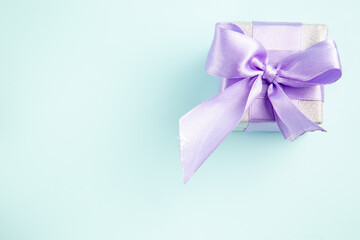 top view cute little present tied with bow on a blue background gift photo xmas new year color