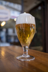 Glass of light beer on a table in the bar