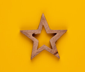 Christmas star decor on yellow colored background.