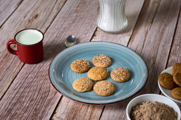 Cookies for dipping in a glass of milk with powdered chocolate