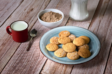 Cookies for dipping in a glass of milk with powdered chocolate
