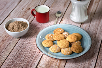 Cookies for dipping in a glass of milk with powdered chocolate
