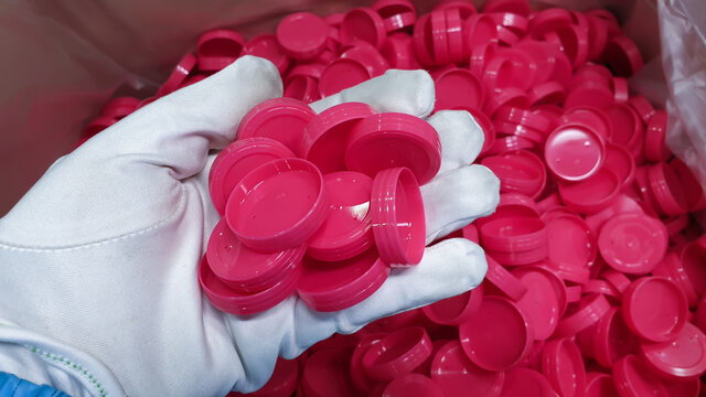 red plastic bottle cap.photo of plastic injection parts on site of plastic factory, in plastics industry.