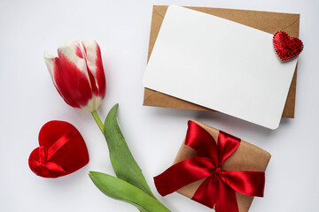 Happy Valentine's Day greeting card. bouquet of red tulips on white background, red heart and space for text
