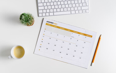 Minimal calendar flat lay.  Monthly calendar for January 2021 in French language, cup of coffee,...