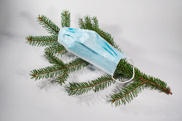 Christmas quarantine: mask and Christmas tree branch