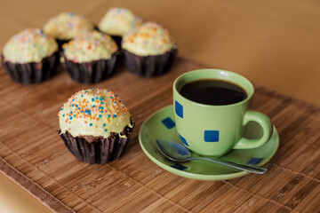 A cup of coffee with capkakes.