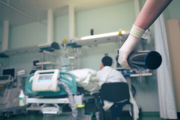 CT scan in the gloved hand of medical doctor on the background of person sitting by the patient's...