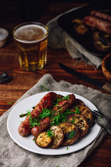 Baked Pork Sausages with Eggplant and Leek on White Plate Garnished with Fresh Herbs