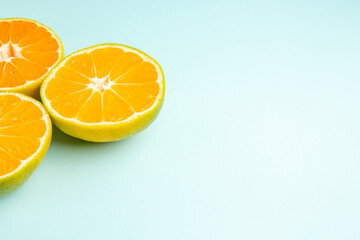 front view fresh tangerine slices on light-blue background photo color orange fruits