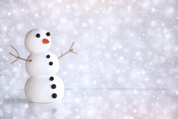Snowfall with Snowman character on winter frozen background with snowflakes with copy space. Mockup, artificial scene, christmas, greeting card, seasonal background. Winter snowing.
