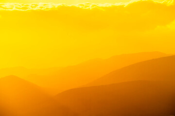 Fototapeta premium Yellow Layers of Mountains, Hills, in Haze, Fog, 