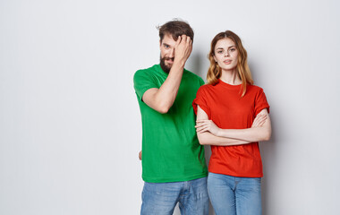 cute young couple in multicolored t-shirts hugs lifestyle fun isolated background