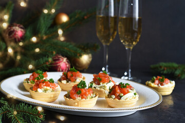 Tartlets stuffed with salad and salmon on a New Year's table.