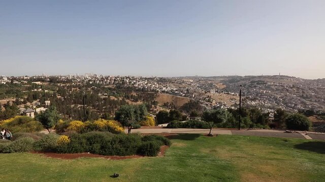 Beautiful morning view of Jerusalem from the mountain. People sit on the mountain and look at the Old Town.