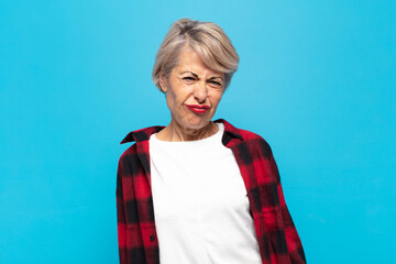 middle age woman looking goofy and funny with a silly cross-eyed expression, joking and fooling...