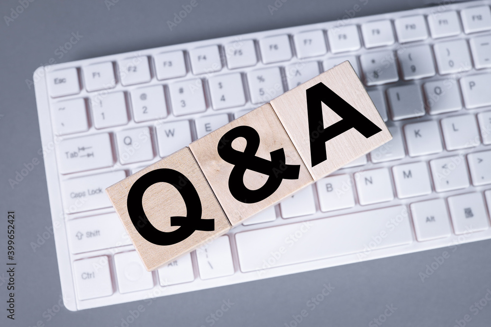 Poster q&a word made with building blocks, business concept. text on wooden cubes on gray background on com