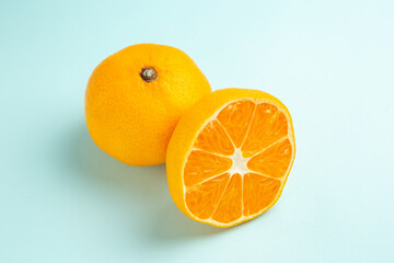 front view fresh tangerine slices on a light-blue background fruit color orange photo juice citrus