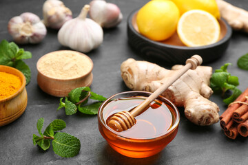 Honey and other fresh products on black table. Natural antibiotics