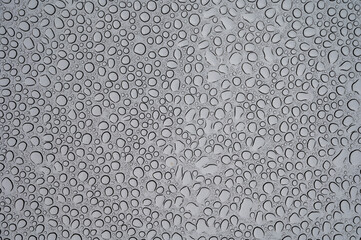 Textured background with rain waterdrops on glass