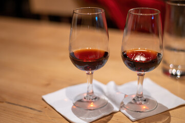 Professional tasting of different fortified dessert ruby, tawny port wines in glasses in porto cellars in Vila Nova de Gaia, Portugal